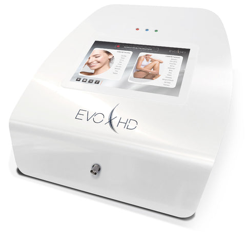 The Silhouet-Tone Evolution 7 HD electrolysis device features a sleek white square body with rounded edges and silver accents. It includes a digital touch screen, offering precision hair removal with three frequencies: 6.78 MHz, 13.56 MHz, and 27.12 MHz. Ideal for various hair types, this device provides advanced treatment options for professionals.