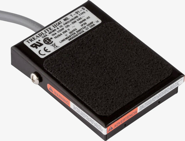 A flat, black electrolysis foot pedal with a non-skid base and foot pad, designed for Hinkel electrolysis machines. The pedal measures 3.5” x 2.5” and includes a round, 3-prong plug, offering easy and effective foot activation.