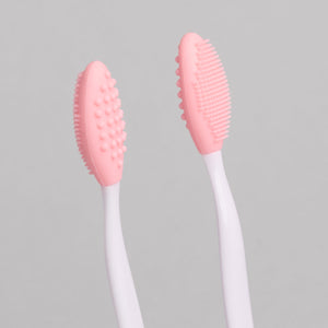 "Exfoliating Eyebrow Brush - A & E Beauty Supplies. pink silicone brush on a white stick"