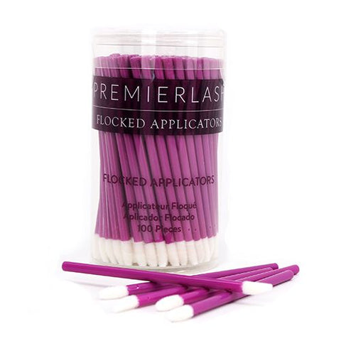 "Flocked Applicators (Qty 100) by PremierLash, ideal for precise application of lash and brow products, displayed on a clean, neutral background, pink stick with a white soft tip in a plastic container