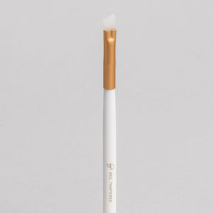 "A sleek silicone brush with a flexible, soft tip for precise application of beauty products, brow, lash, and skincare treatments, displayed on a clean, neutral background." 