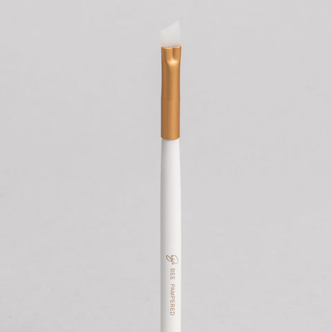 "A sleek silicone brush with a flexible, soft tip for precise application of beauty products, brow, lash, and skincare treatments, displayed on a clean, neutral background." 